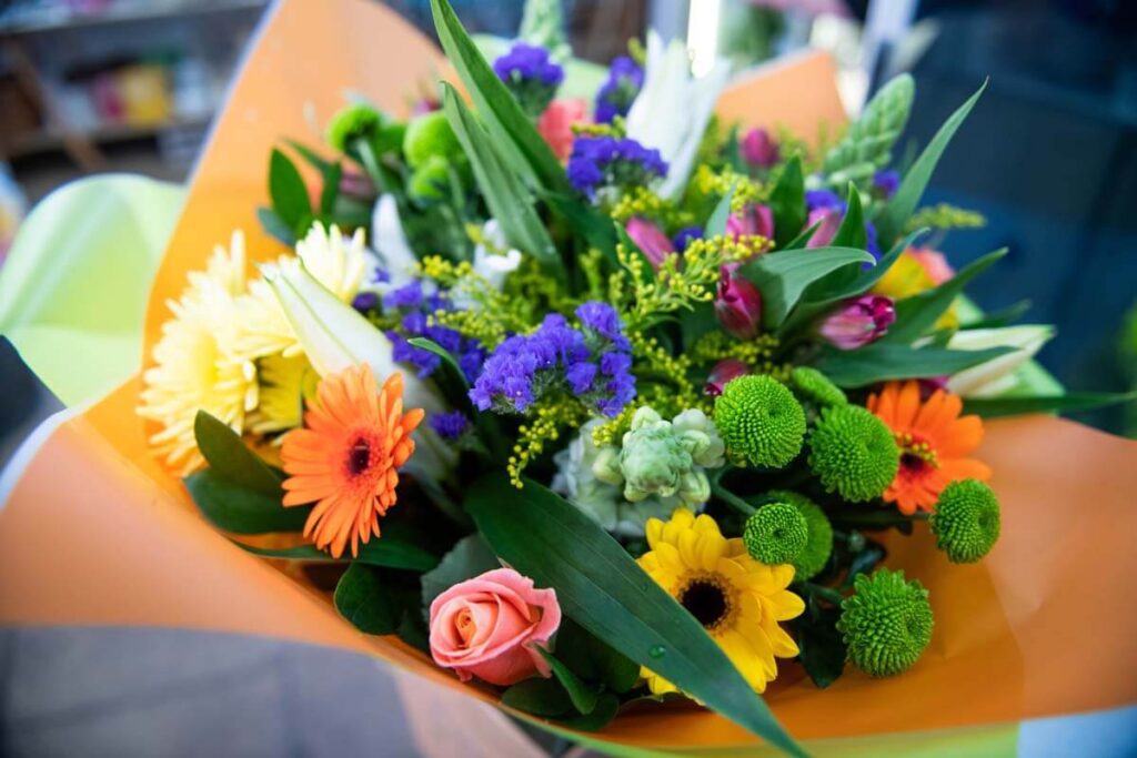 Bright mixed flower bouquet with roses, gerberas and greenery